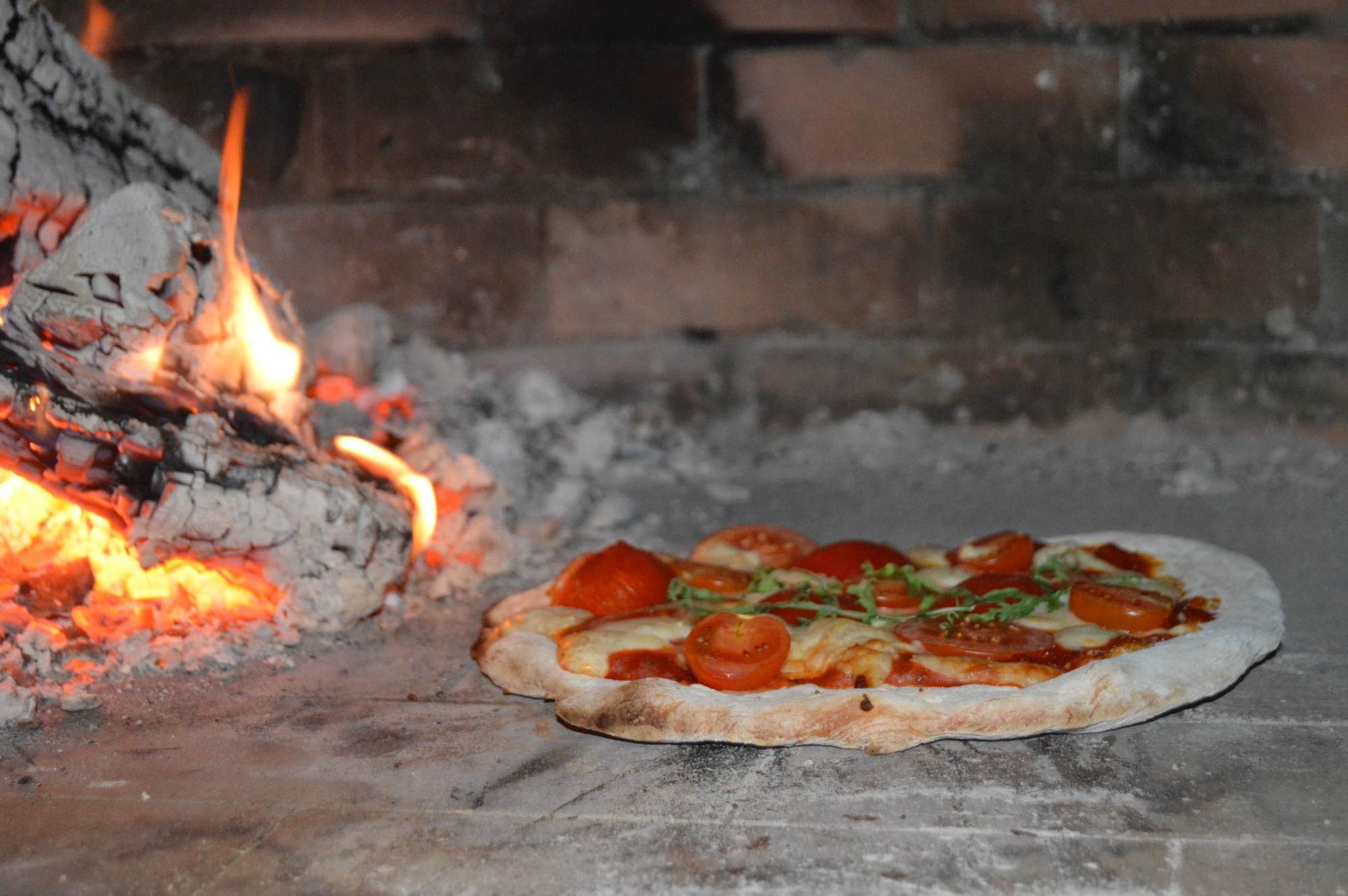 pizza in oven The BOARD INN